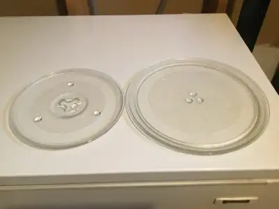 I'm offering two used microwave turntable plates, perfect for replacing a broken or missing one. The...