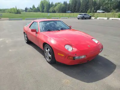 This classic 1987 Porsche 928 S4 is finished in an iconic Guards Red exterior and features a powerfu...