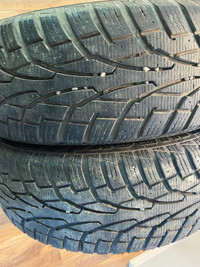 Two Uniroyal Tigerpaw 225/65R17 winter tires.