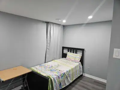 Two clean, furnished rooms are available in a quiet, well‑maintained female‑only basement near Rossl...