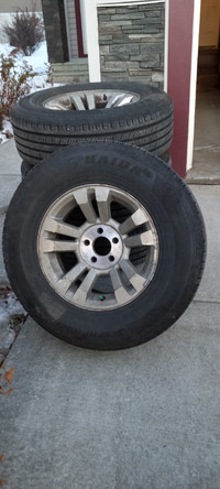 set of four tires on aluminum rims.