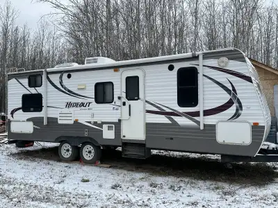 Selling a 2013 Keystone Hideout. Large slide out. Sleeps 8(Queen bed, hide-a-bed couch, 2 single bun...