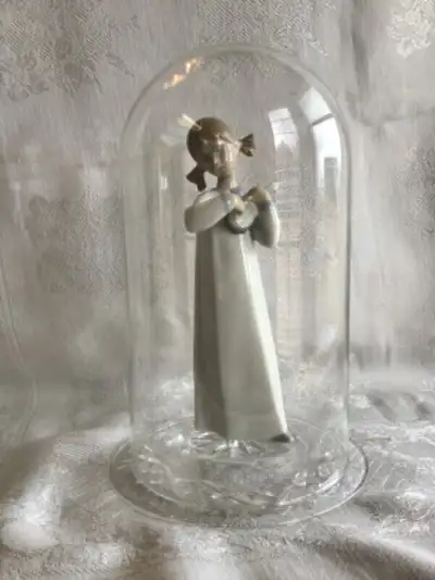 Lladro girl holding Ukulele figurine. $40.00 Glass display Dome. $35.00