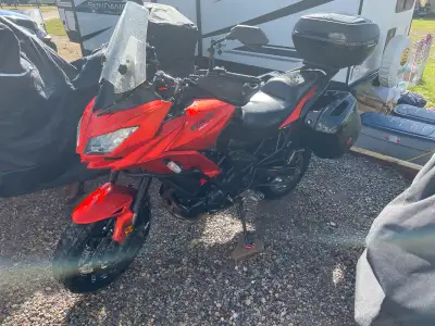 It comes with bags that are keyed to the bike, heated grips, crash bars, better foot pegs and handle...
