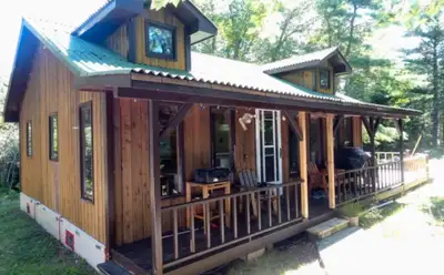 Discover the serenity of waterfront living with this charming riverfront cottage. This cozy retreat...