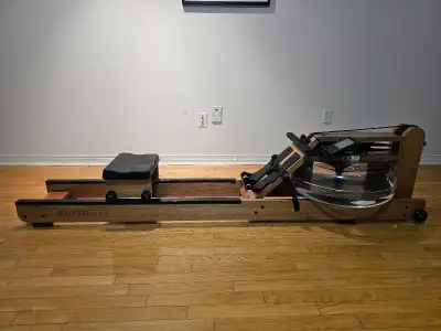 Get ready to row, row, row your way to fitness with this Battife rowing machine! This used water row...