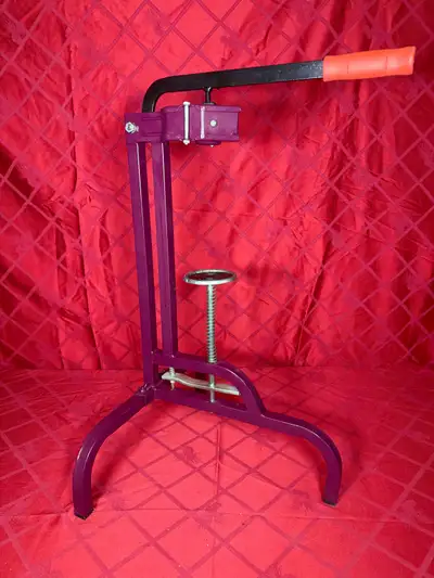 Sturdy purple floor wine bottle corker. Has a black lever handle with an orange grip. Like new condi...