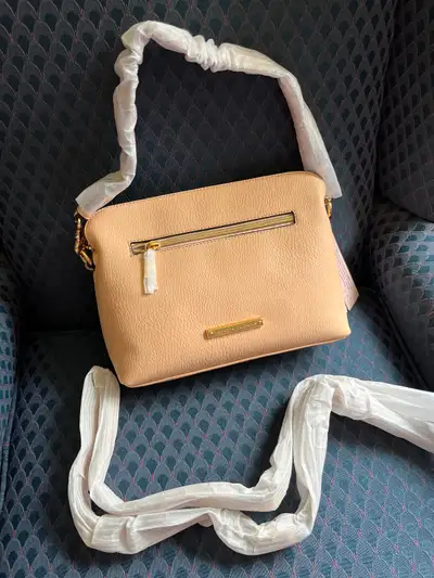 Crossbody handbag with lots of interior pockets and divisions Size is appropriate- 10 x8x2.5 - 3 inc...