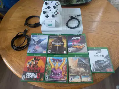 Xbox One S with two controllers with charging base and seven games comes with everything seen in pic...
