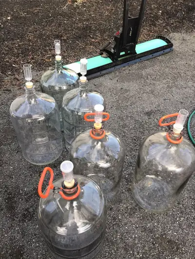 23 litre glass carboys. Two with air locks and handles 30.00 each. Six with air locks 25.00 each.oth...
