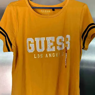 This is a brand new Guess Los Angeles T-shirt in a size XL. The T-shirt is yellow with black stripes...