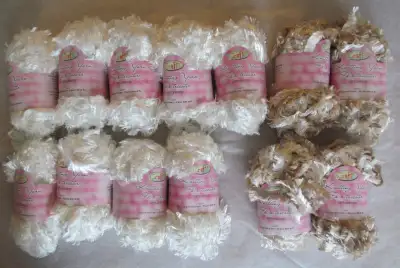 Bulk lot of yarn. Thirteen (13) rolls of yarn comprised of 9 white coloured and 4 beige coloured. Ap...