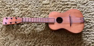 This is a vintage ukulele with a unique charm, perfect for collectors or anyone looking for a distin...