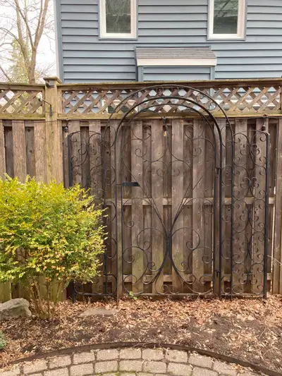 Ornamental Wrought Iron Entrance Gate - overall width 76 “ Overall height 84” at center Gate swings...