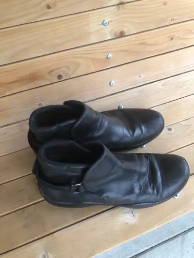 These are a pair of black leather ankle boots by Prada usa 8. , View more