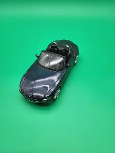 Perfect for your collection! A detailed 1:18 scale diecast model of a BMW Z4 convertible. It's a dar...