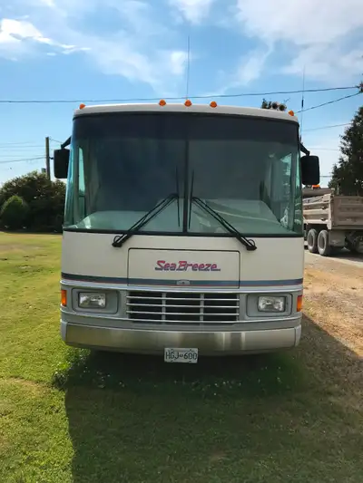 White and lilac motorhome in beautiful condition. The motor is a Ford super duty automatic overdrive...