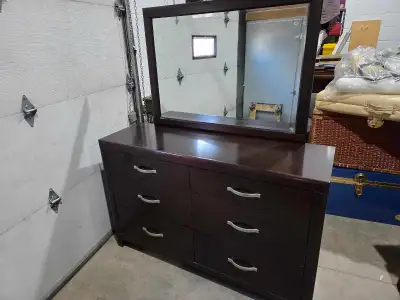 This DeFehr dresser and mirror combo, crafted in Winnipeg, Manitoba, offers both style and functiona...