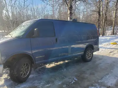Tinted windows, rear interior is sprayfoamed and framed in for a queen sized bed. Trailer hitch in t...