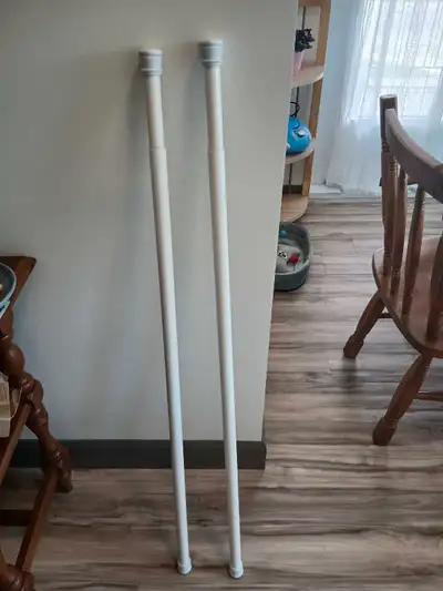Set of two white tension rods for curtains, shower curtains, etc. Can extend between 3 feet 4 inches...