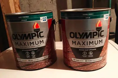 Two,1 gallon cans of Olympic Stain + Sealant, solid stain in the color "Ebony Gray. One can was open...