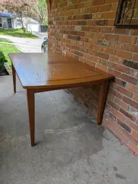 Solid wood table with extra leaf.