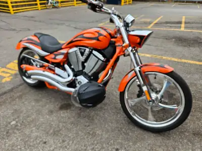 Check out this Victory Jackpot, a real head-turner with its striking orange custom paint job and pow...