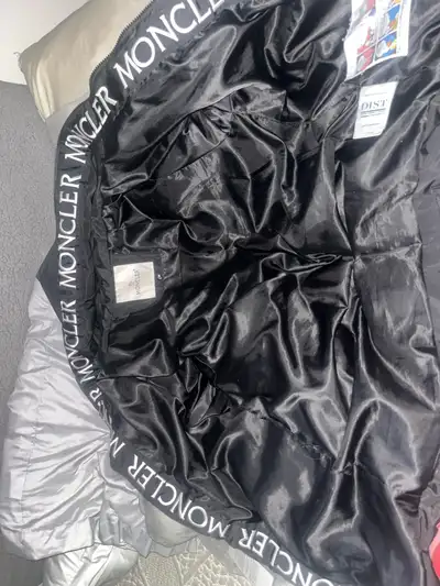 Stay warm and stylish with this sleek black Moncler jacket, perfect for braving the Canadian weather...