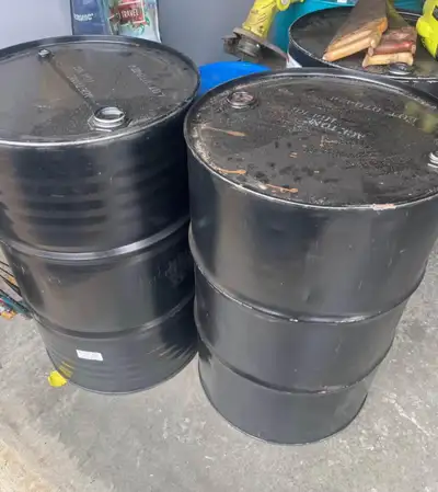 Steel 55 gallon 208L) drums with non-removable tops (screw in caps only). Makes a great burn bin or...