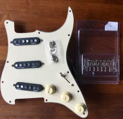 I have two excellent loaded pickguards that will greatly improve your Squier Strat. Option 1 is SSS...