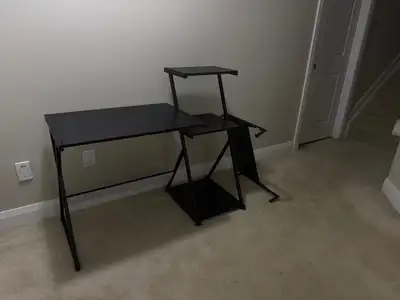 Black computer desk with shelves and a metal frame, as pictured. Measures 48 inches wide by 22 inche...