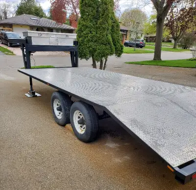 18' long deck, (14' flat & 4' beaver tail), 5000 lb axels good tires, electric brakes, grey primer a...