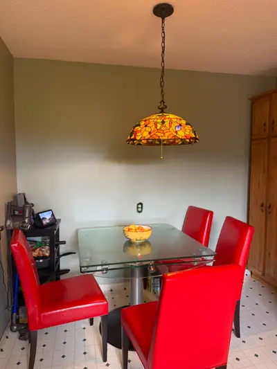 Glass kitchen table with 4 red leather chairs, View more