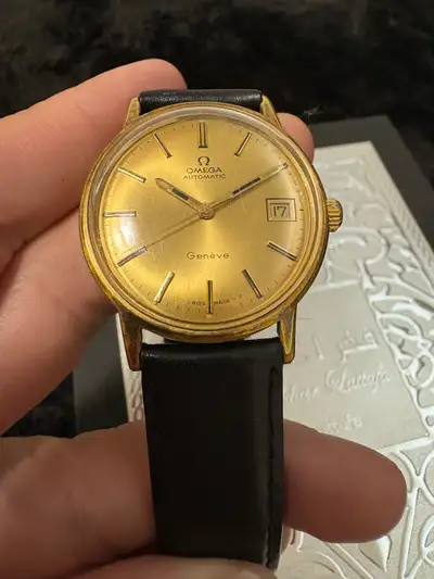 This OMEGA Geneve Automatic is a vintage timepiece, featuring a gold-tone finish and automatic movem...