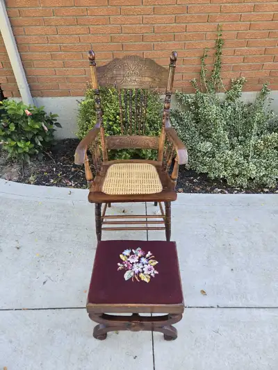 Great looking vintage press back arm chair with cane seat. Comes with a needlepoint footstool. Both...