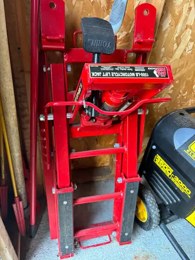 This is a used Torin Big Red 1500-lb motorcycle lift jack, perfect for motorcycle maintenance and re...