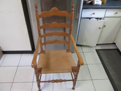 Up for sale is a vintage hand made solid wood wicker woven seat high back dinner chair with arm rest...