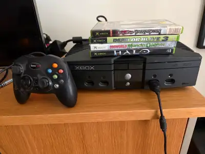 First-gen XBox, jailbroken via hardware mod. Four games, 3rd party controller and various video outp...