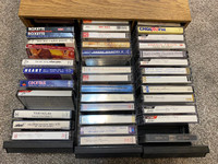 THE CASSETTE CASE INCLUDES A VARIETY OF COUNTRY MUSIC CASSETTES
