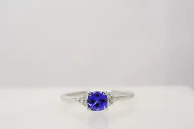 SIZE: 7 KARAT: 14K METAL: WHITE GOLD STONE: .55CT TANZANITE (GOOD CUT), 6 X .09CT MELEE DIAMONDS (SI...