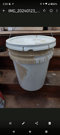 Two buckets of beige paint 