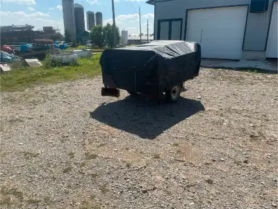 6 feet long by 5 feet wide by 2 feet high (28" overall) Covered Utility Trailer with 1000lb carrying...