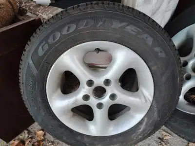 Used 15-inch aluminum rim with Goodyear winter tire. Measurements and markings visible in photos. Go...