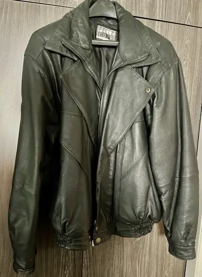Black genuine leather jacket. Sz med 28” long. Elastic bottom zippered and snap closure. Fully winte...