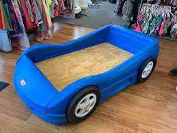 Blue car bed Kid will love it as his first or new bed Comes with mattress but the bottom of it is ri...
