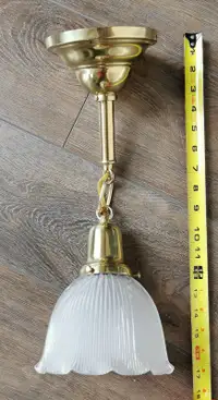 Heavy brass ceiling light fixture with frosted glass shade