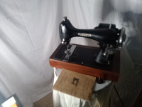 Vintage seamstress sewing machine with foot.