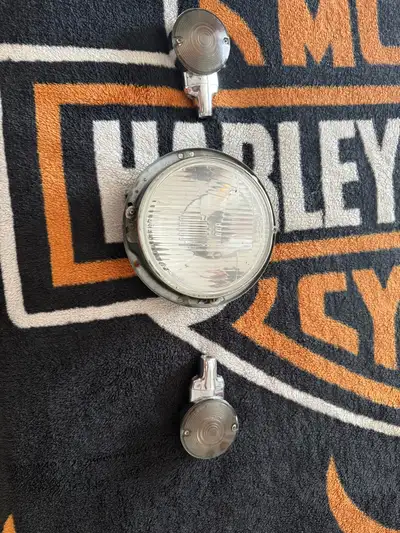 Harley Davidson headlamp and turn signals. These parts are in good condition, and are ready to insta...