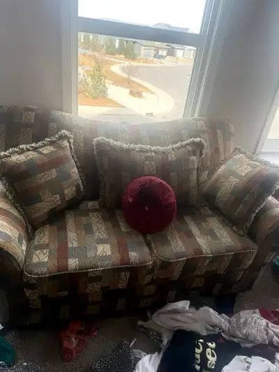 Selling a comfy two-seater sofa with a unique patterned design! It comes with matching pillows, perf...