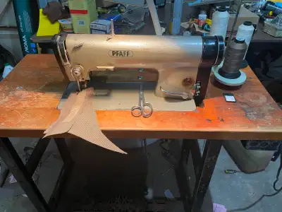 PFAFF 463- The primary machine model head. It is a single-needle, high-speed flatbed drop-feed sewin...
